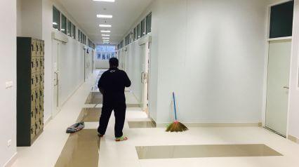 Janitor ensuring cleanliness with school cleaning checklist