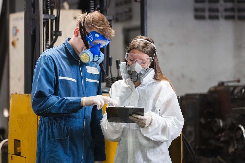 Safety officers inspecting hazardous materials using software technology