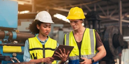 two safety managers assessing an organization's safety performance using analytics on a tablet