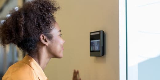 an employee getting her biometrics taken before entering the workplace to aid AI in safety management