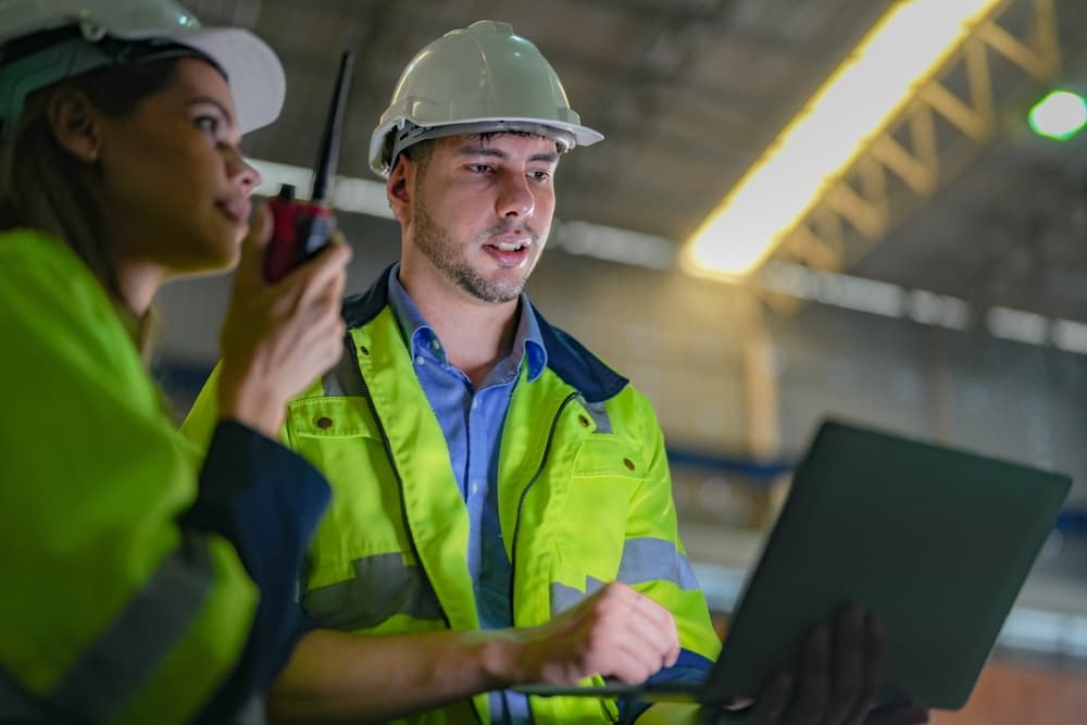 Two inspectors doing internal control checks using a technological platform