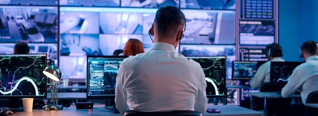 A security officer doing facility monitoring using physical security software