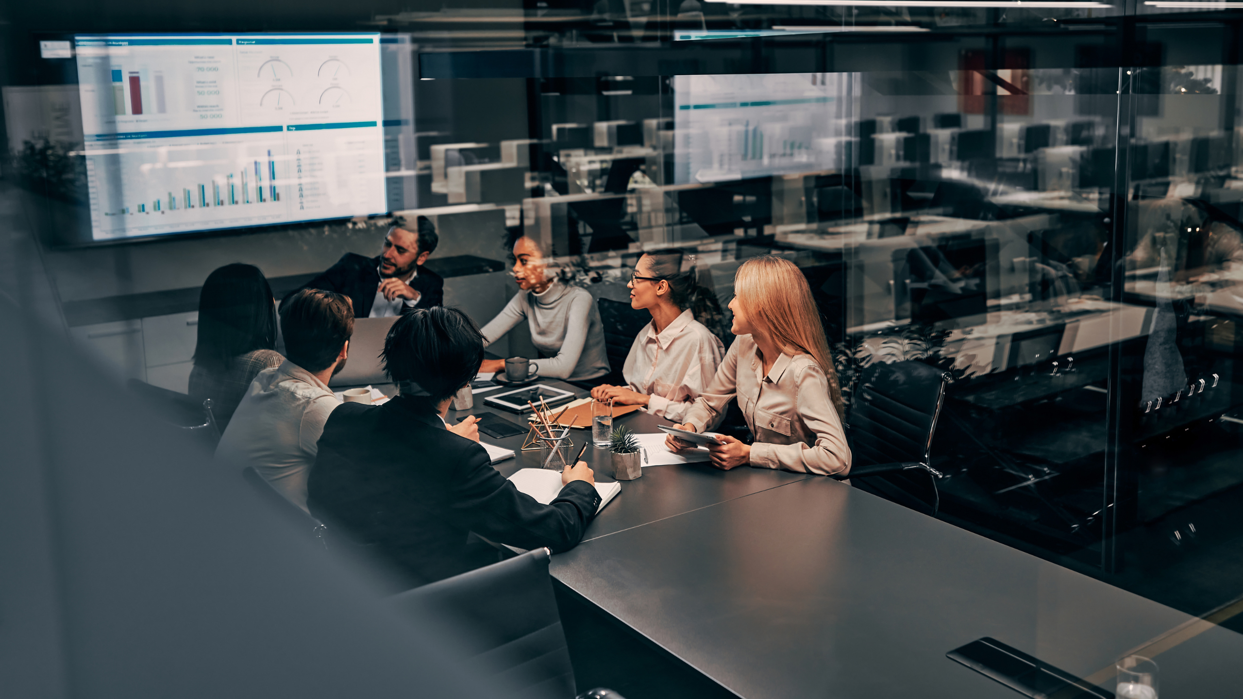 A group of senior managers discussing policy management within the organization