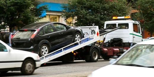 tow truck getting a car as part of fleet accident management