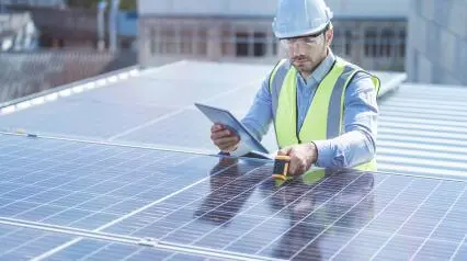 worker conducting solar panel maintenance with a digital checklist|Solar Panel Maintenance Checklist Sample Report|Solar Panel Maintenance Checklist