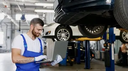a vehicle maintenance personnel using a vehicle condition report template on a laptop to document overall vehicle condition|Sample Vehicle Condition Report|Vehicle Condition Report Template
