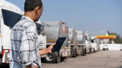 a truck driver using a vehicle pre start checklist on a tablet after conducting a pre start check|Vehicle Pre Start Checklist Sample Report|Vehicle Pre-Start Checklist