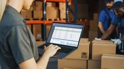a supply chain manager conducting a procurement management audit using a laptop