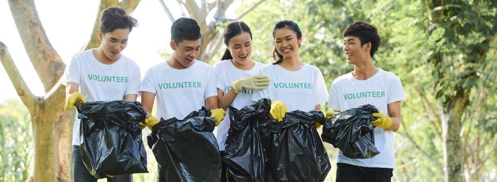 five employees volunteering on an environmental cause as part of the company's ESG efforts listed on an ESG software|AuditBoard ESG Software|Conservice ESG Software|Convene ESG Software|Ecometrica ESG Software|NAVEX ESG Software
