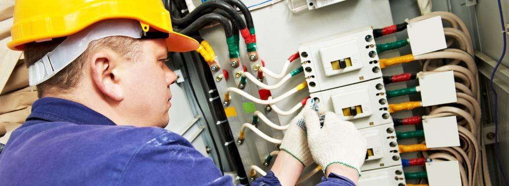 an electrical engineer checking electrical systems during a fire risk assessment while using a fire risk assessment software|ClickFRA by AT&F|Vision Pro|Collabit|FireMate|Mobiess|Aurora