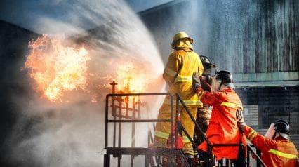 two firefighters being trained on fire safety