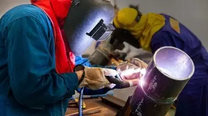 person in ppe gas welding