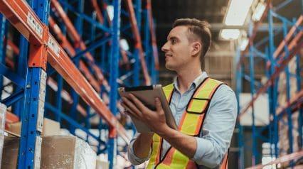 a manufacturing supervisor checking inventory controls in a warehouse during an internal audit