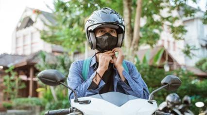motorcycle rider buckles his helmet for motorcycle safety