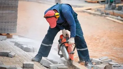 a construction worker wearing earmuffs to protect himself from a noise hazard while working