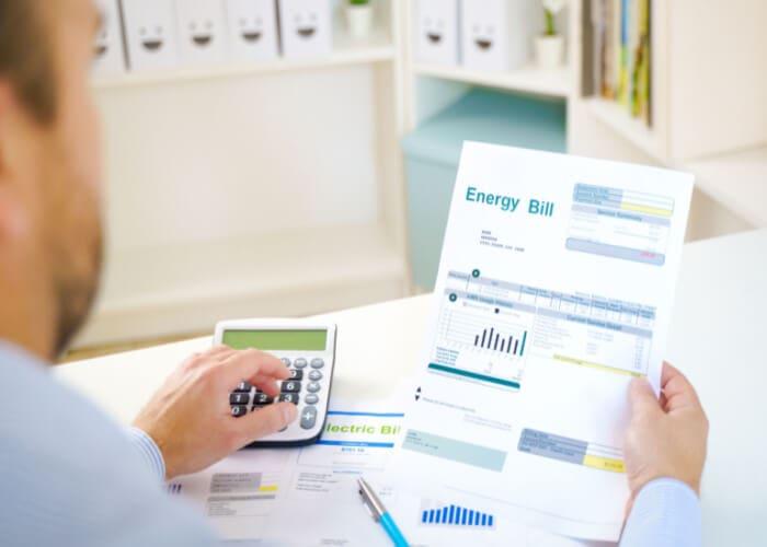 Man looking at his energy bills considering switching energy supplier