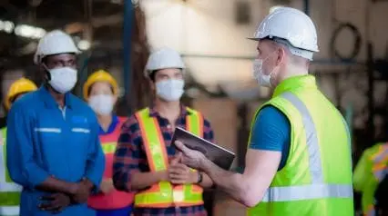 a warehouse manager conducting a safety briefing on warehouse safety topics