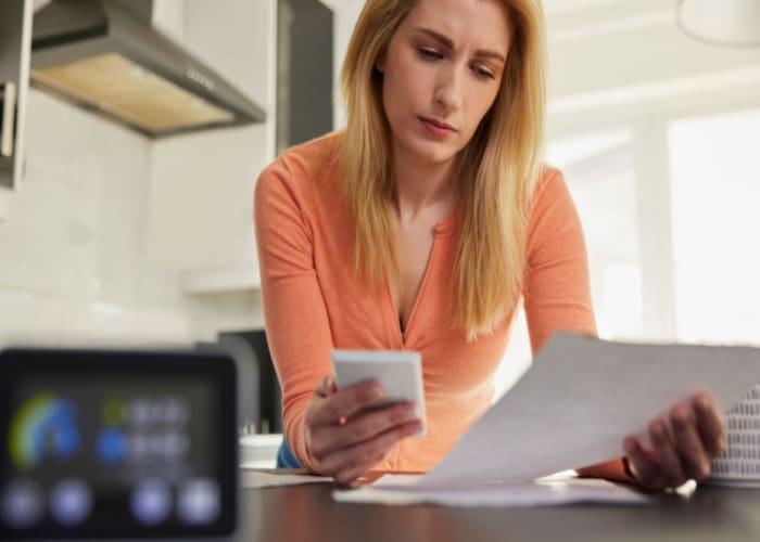 Woman looking at energy costs and considering switching energy service provider