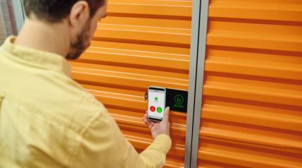 person accessing a storage by using a sensor with a mobile on hand