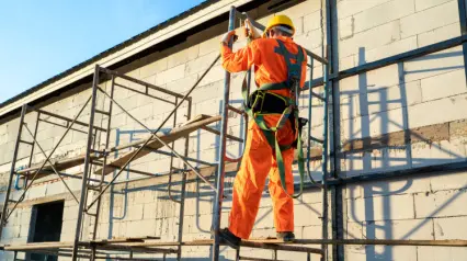 a construction worker wearing ppe and fall protection