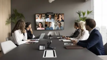 Group of colleagues in a meeting with people online