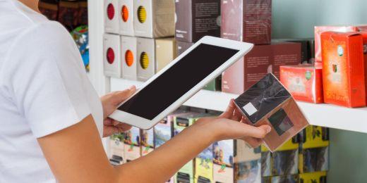 retail worker utilizing the benefits of retail digital transformation with a tablet for inventory management