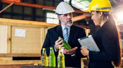 two manufacturing supervisors assessing product quality