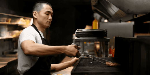 Cook placing food for hot holding