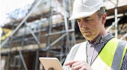 worker doing residential construction with tablet