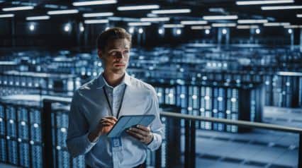 an IT security professional checking security systems using a security audit checklist on a tablet|Security Audit Checklist Sample Report|Security Audit Checklist