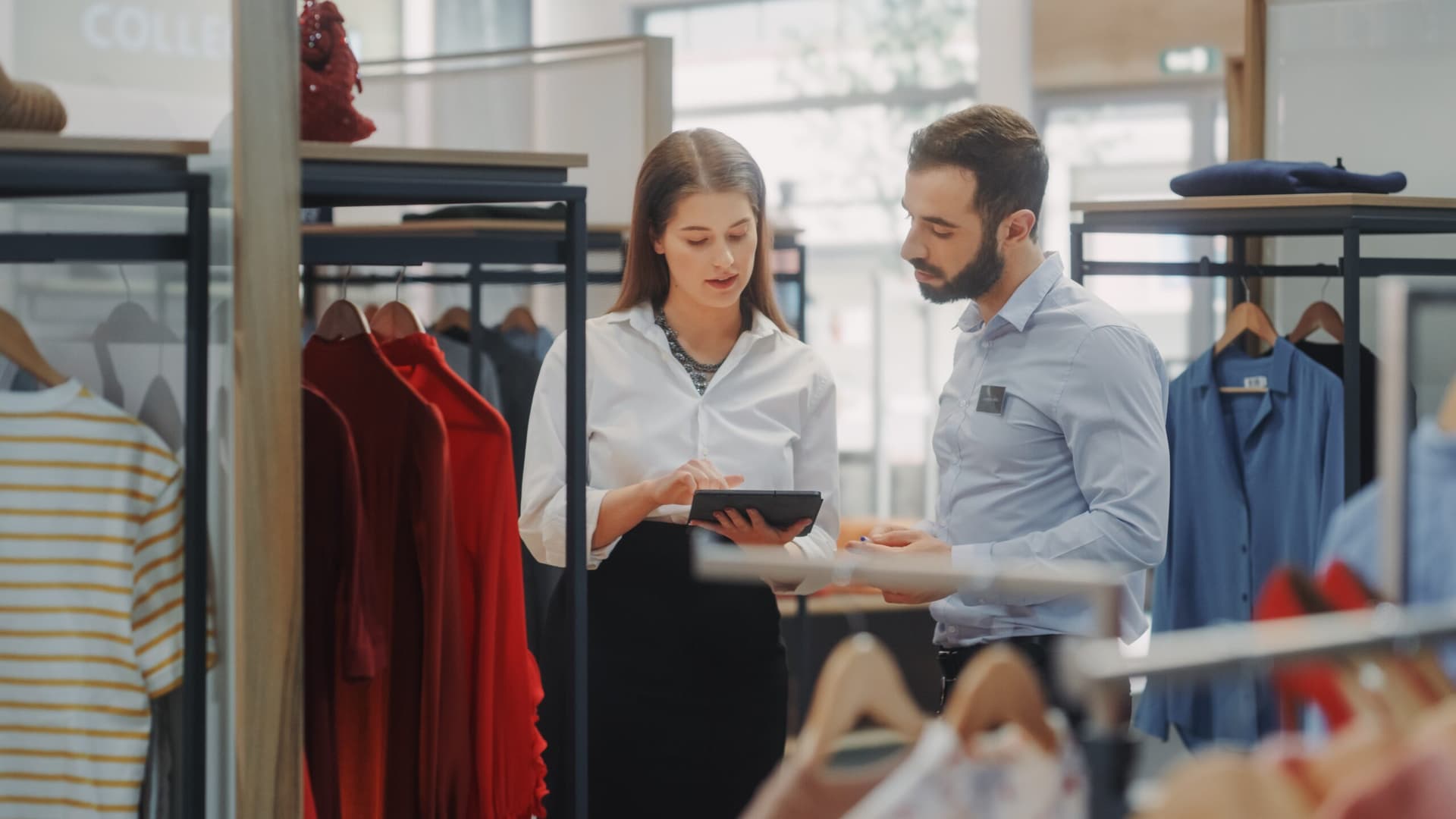 Two storekeepers using retail management software