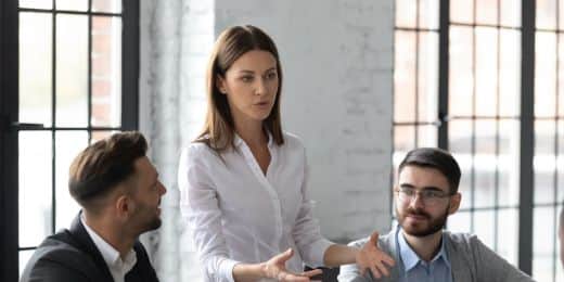 a manager relaying operational changes to a group of employees via a change communication meeting