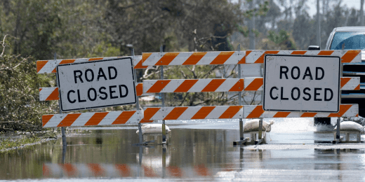 Road closure signs on a flooded street