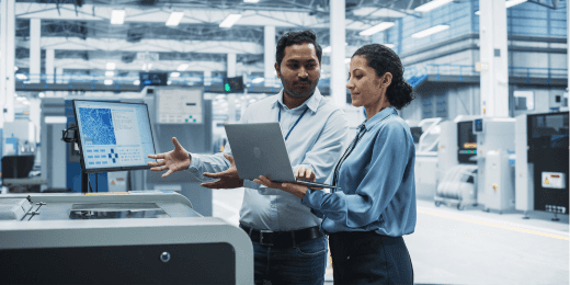 Two workers doing manufacturing process management checks