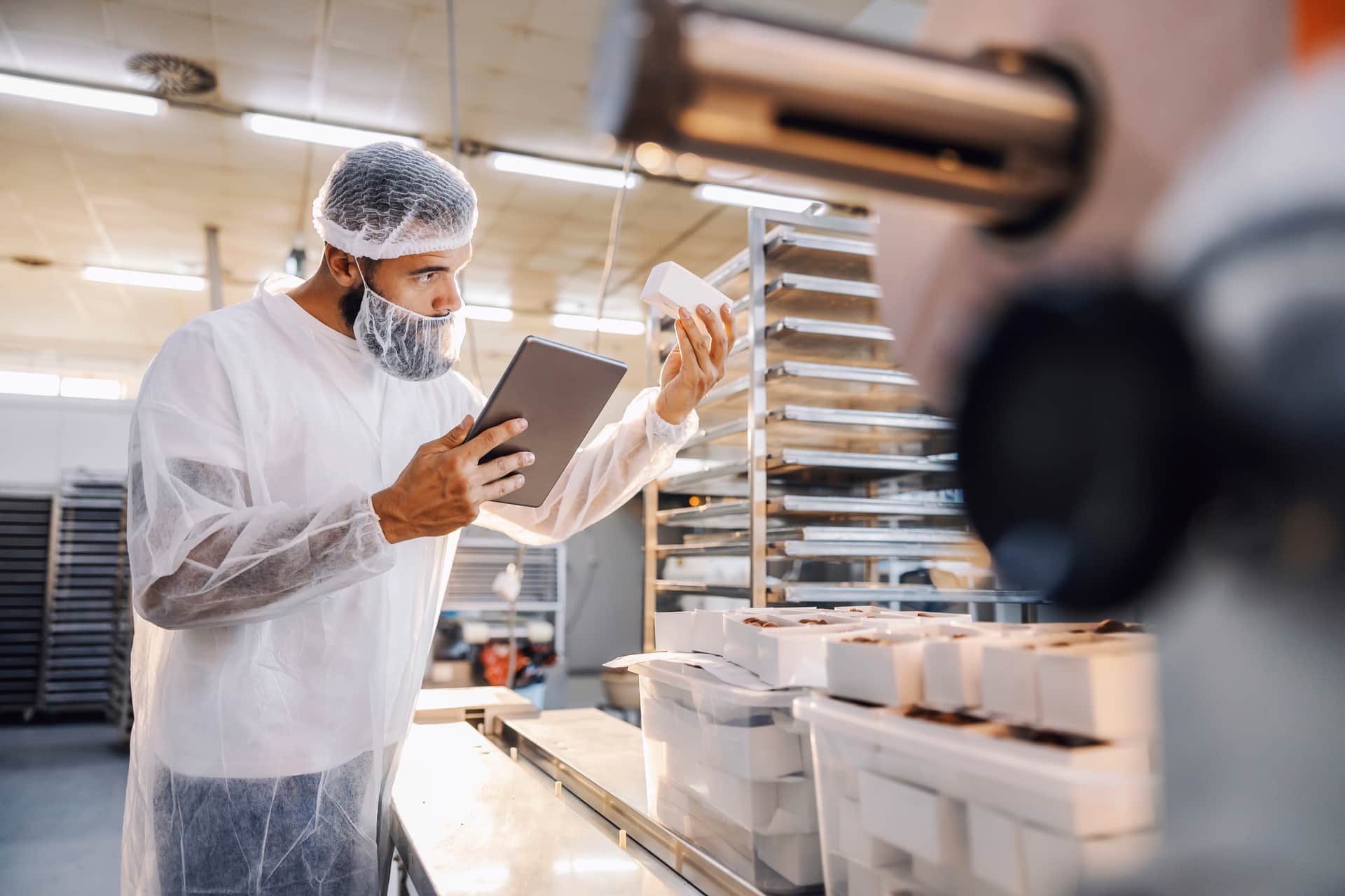 A worker is using a food safety training plan template.