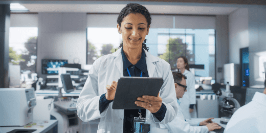 Woman in a lab coat holding a tablet checking the 5 core tools of quality for production