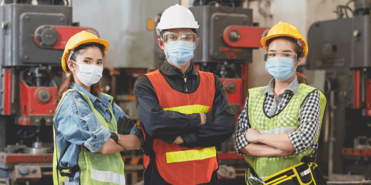 Three engineers promoting safety by wearing Personal Protective Equipment (PPE).
