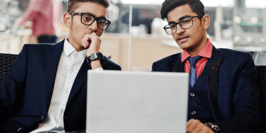 Two office workers are practicing effective workplace management.