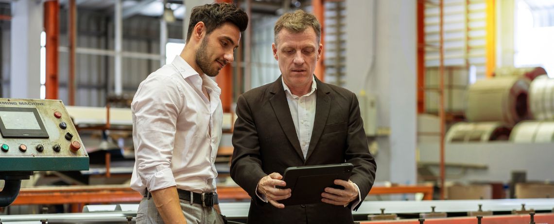 two quality supervisors checking quality improvement opportunities from inspections using a tablet