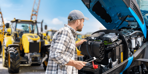 An engineer inspecting a tractor for equipment maintenance.
