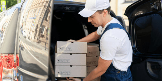 A man handling delivered food and beverages.