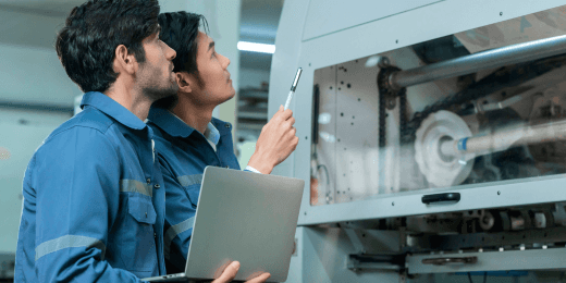 Two workers are doing an asset risk assessment.