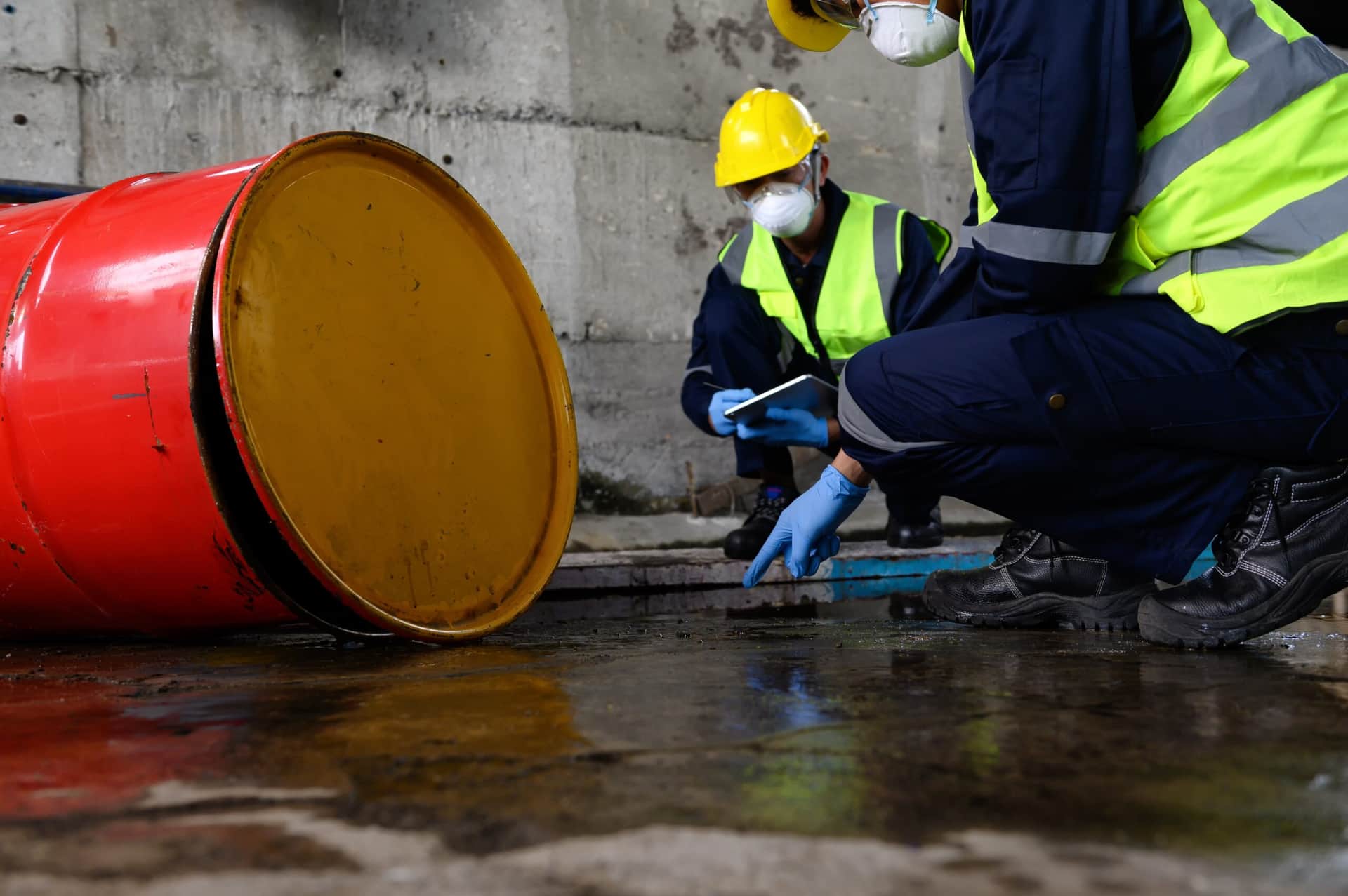 Two safety officers examining a hazardous spill.