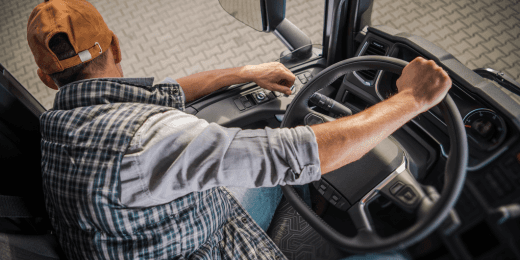 Truck driver operating a vehicle during a CDL driving test.