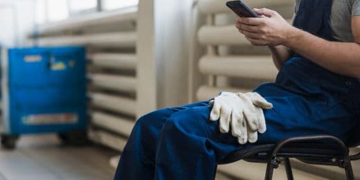 hotel maintenance worker accomplishing kpi report on phone