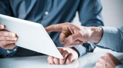 two people using an audit plan template on a tablet|Audit Plan Template Sample Report|Audit Plan Template