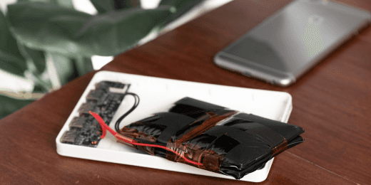 A phone's lithium-ion battery with exposed wires.