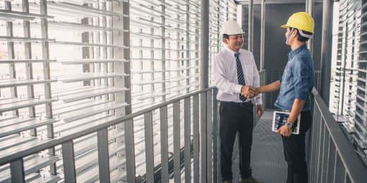 two contractors talking about a contract using ai in contract management in tablet