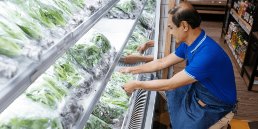 A worker is conducting an inspection for the food storage temperature control checklist.