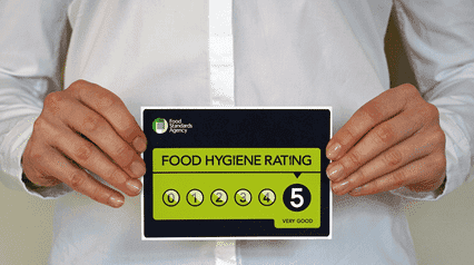 two chefs practicing proper food hygiene measures